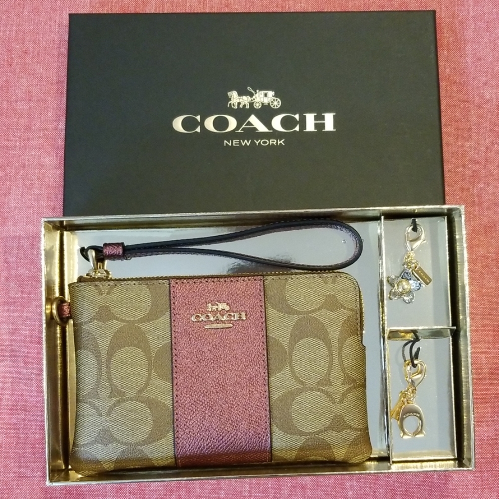NWT Coach wristlet 2 charms. Metallic wine Brown